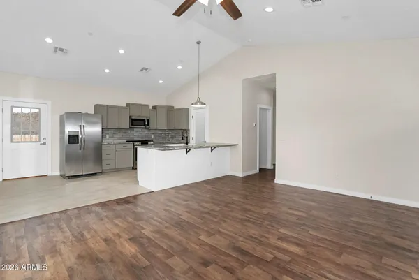 a view of kitchen with refrigerator microwave and stove