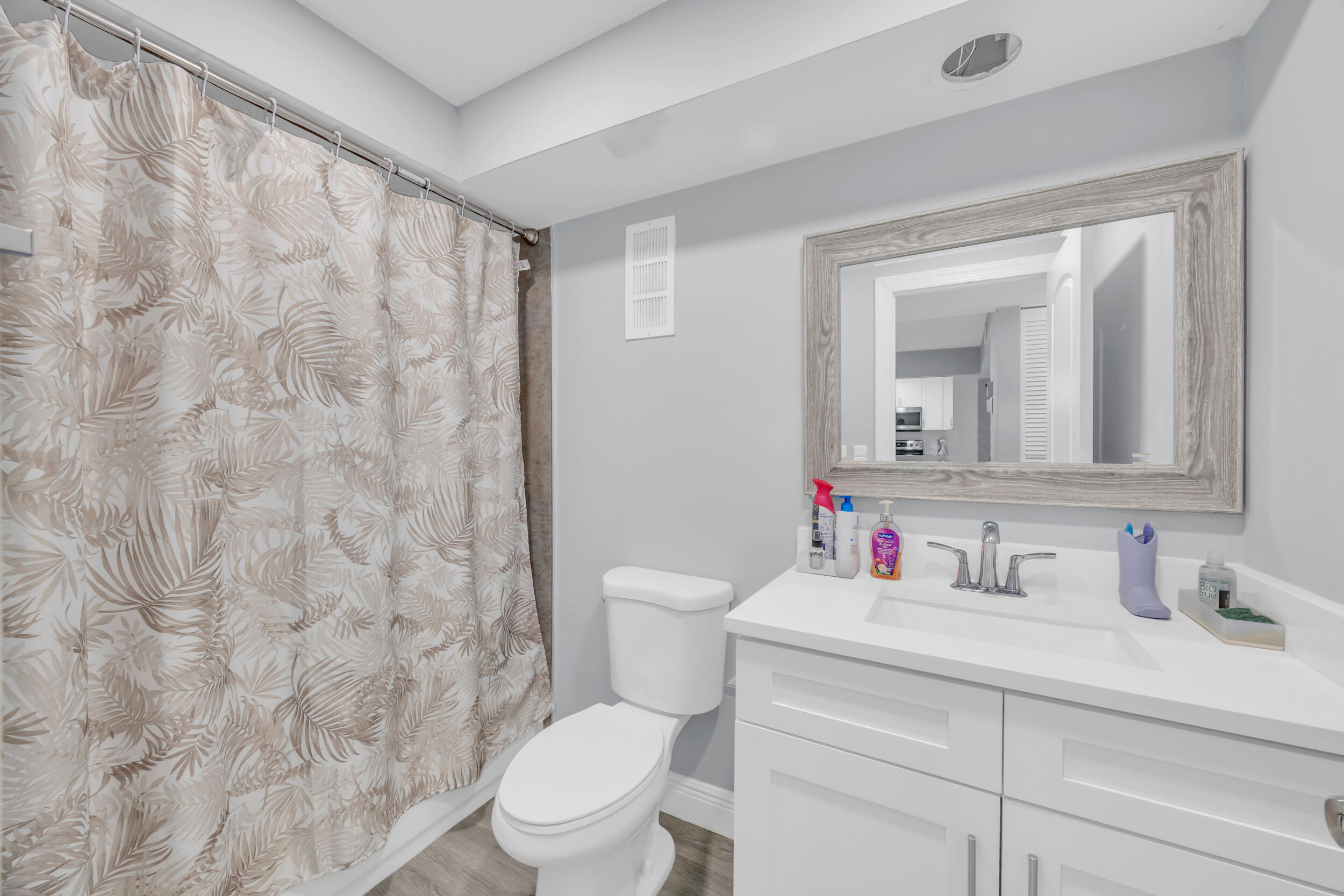 470 Northwest 20th Street, Unit 1050 Boca Raton, FL 33431 - Photo 21 of 28 a bathroom with a toilet sink vanity and mirror