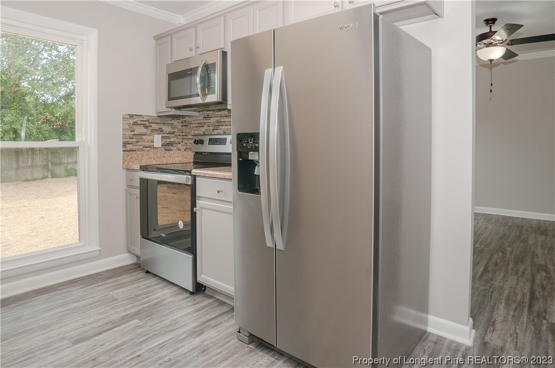 3313 Red Fox Road Spring Lake, NC 28390 - Photo 12 of 33 a kitchen with white cabinets and stainless steel appliances