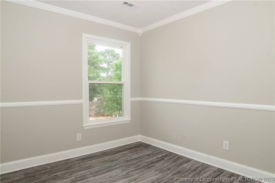 3313 Red Fox Road Spring Lake, NC 28390 - Photo 18 of 33 a view of an empty room with wooden floor and a window