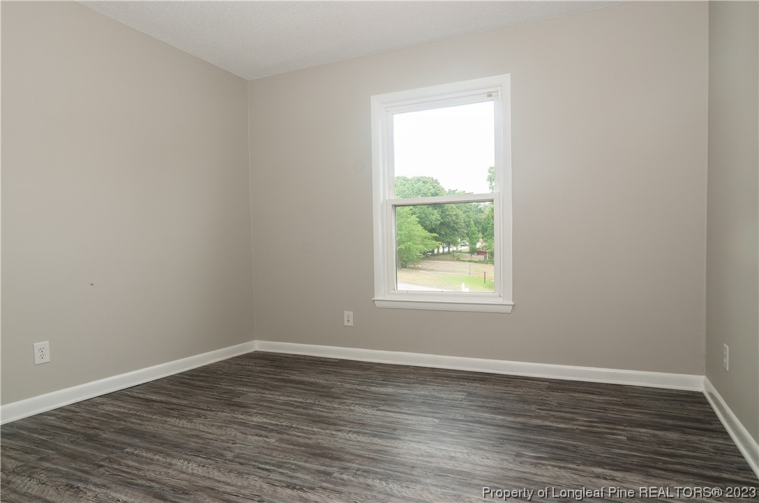 3313 Red Fox Road Spring Lake, NC 28390 - Photo 20 of 33 an empty room with wooden floor and window