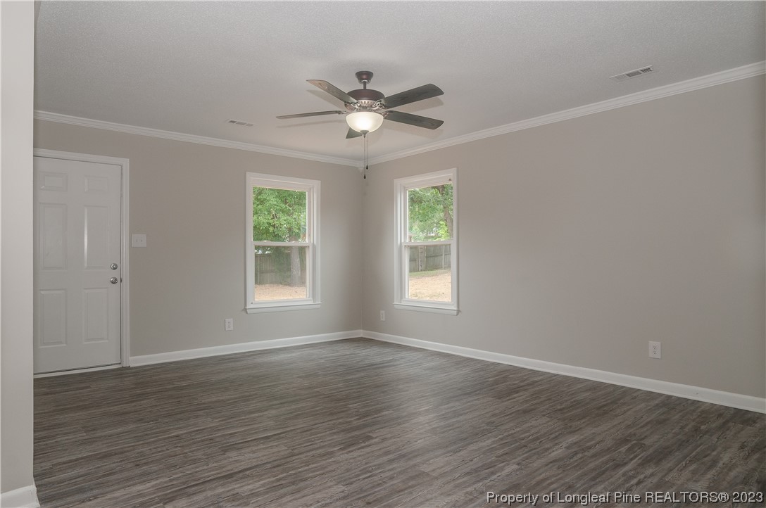 3313 Red Fox Road Spring Lake, NC 28390 - Photo 5 of 33 a view of an empty room with wooden floor and a window