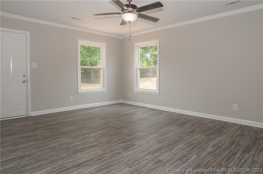 3313 Red Fox Road Spring Lake, NC 28390 - Photo 9 of 33 a view of an empty room with wooden floor and a window