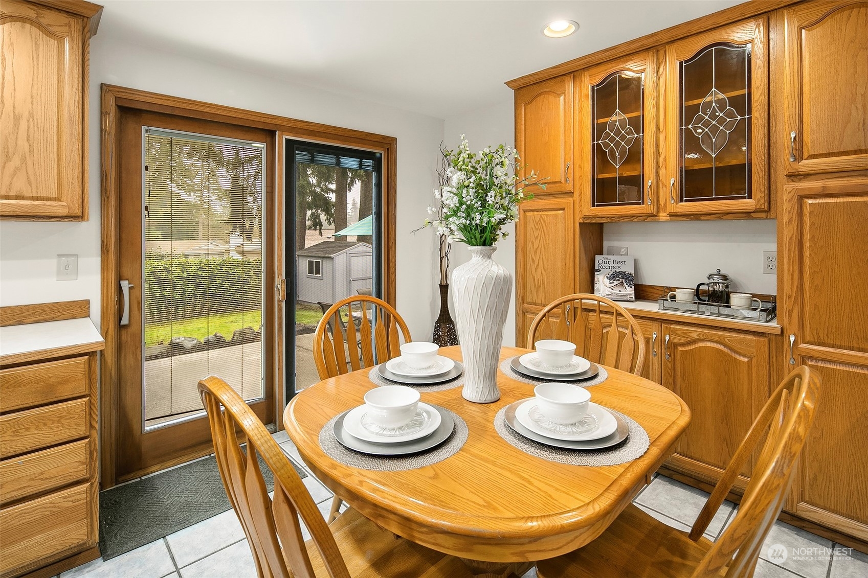 102 217th Place Southwest Bothell, WA 98021 - Photo 13 of 32 a view of a dining room with furniture large windows and wooden floor