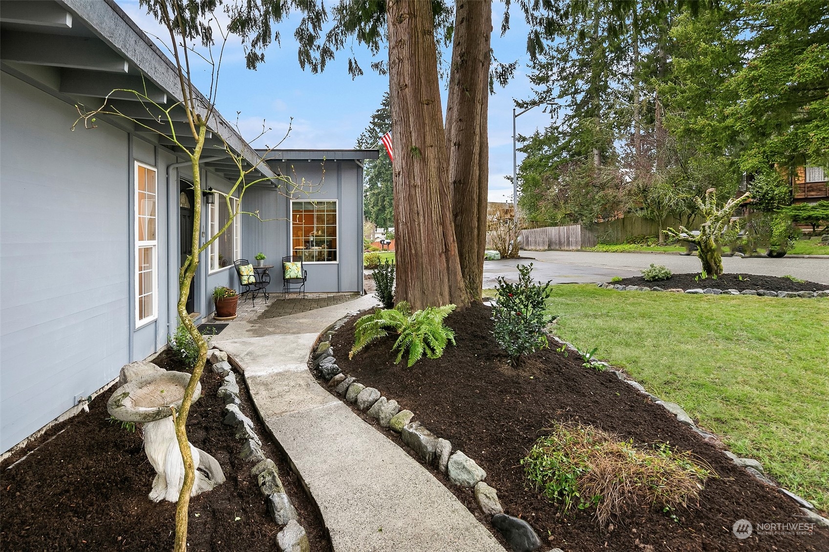 102 217th Place Southwest Bothell, WA 98021 - Photo 3 of 32 a front view of a house with garden
