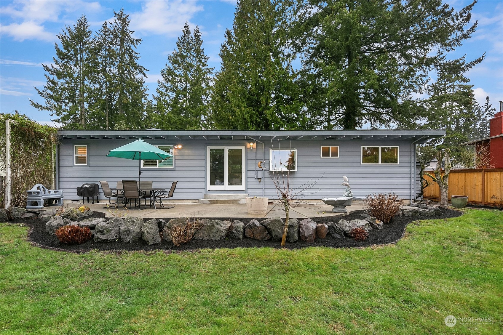 102 217th Place Southwest Bothell, WA 98021 - Photo 5 of 32 a backyard of a house with table and chairs