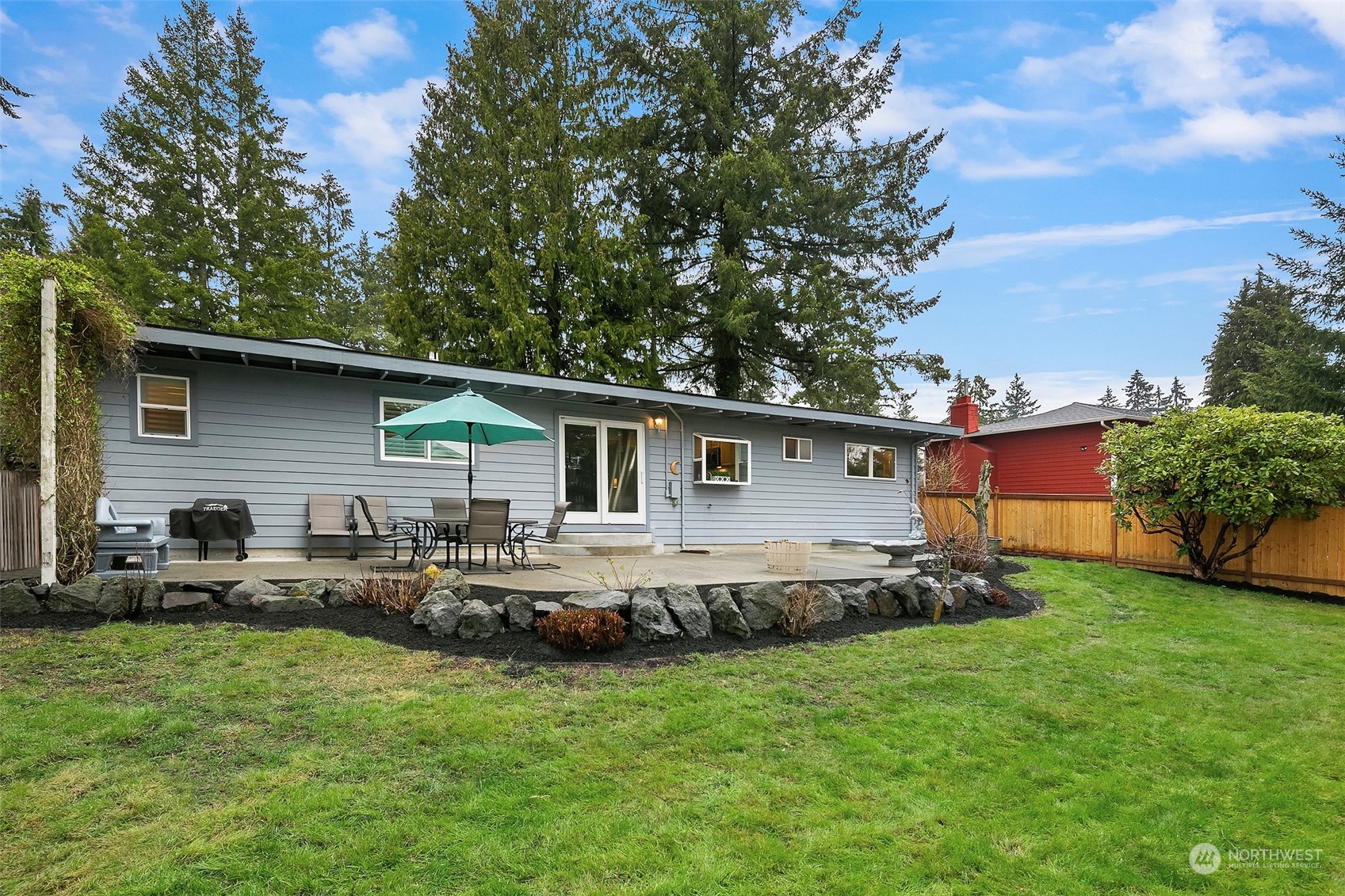 102 217th Place Southwest Bothell, WA 98021 - Photo 6 of 32 a backyard of a house with yard table and chairs