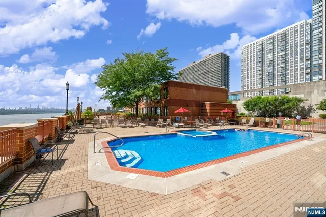 a view of swimming pool with outdoor seating