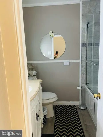 a bathroom with a toilet a sink and shower