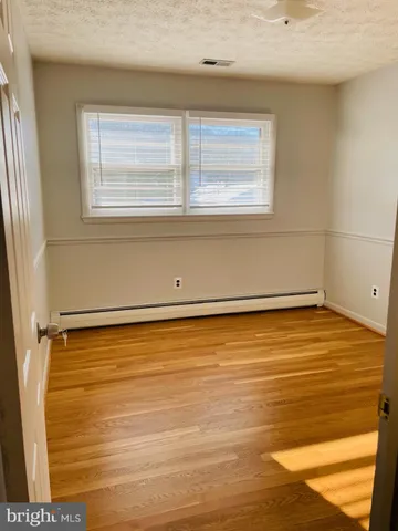 a view of a room with wooden floor and bathroom