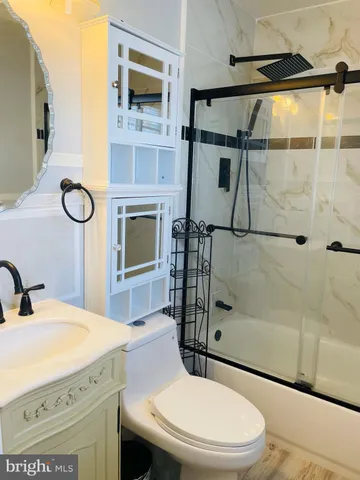 an empty room with wooden floor chandelier fan and windows