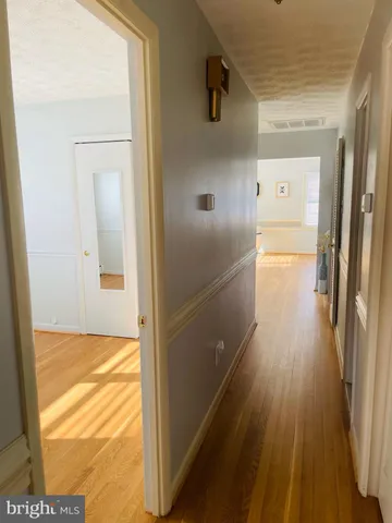 a view of staircase with lots of frames on wall and a window