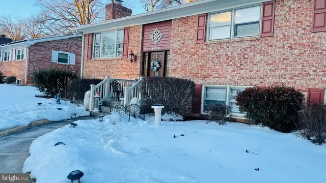 a view of a house with a yard and a porch