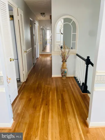 a view of a room with window wooden floor and kitchen view