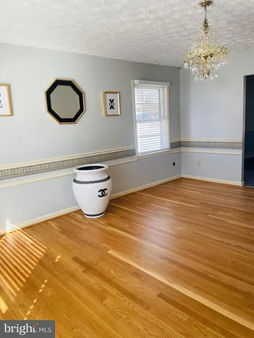 a view of hallway with wooden floor