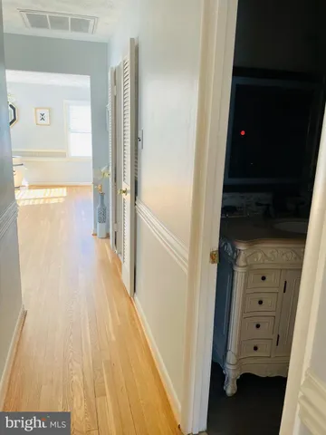 a view of a room with a ceiling fan and window