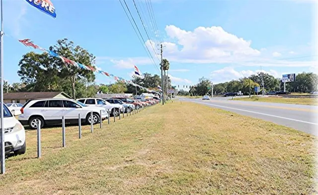 a swimming pool with lawn chairs