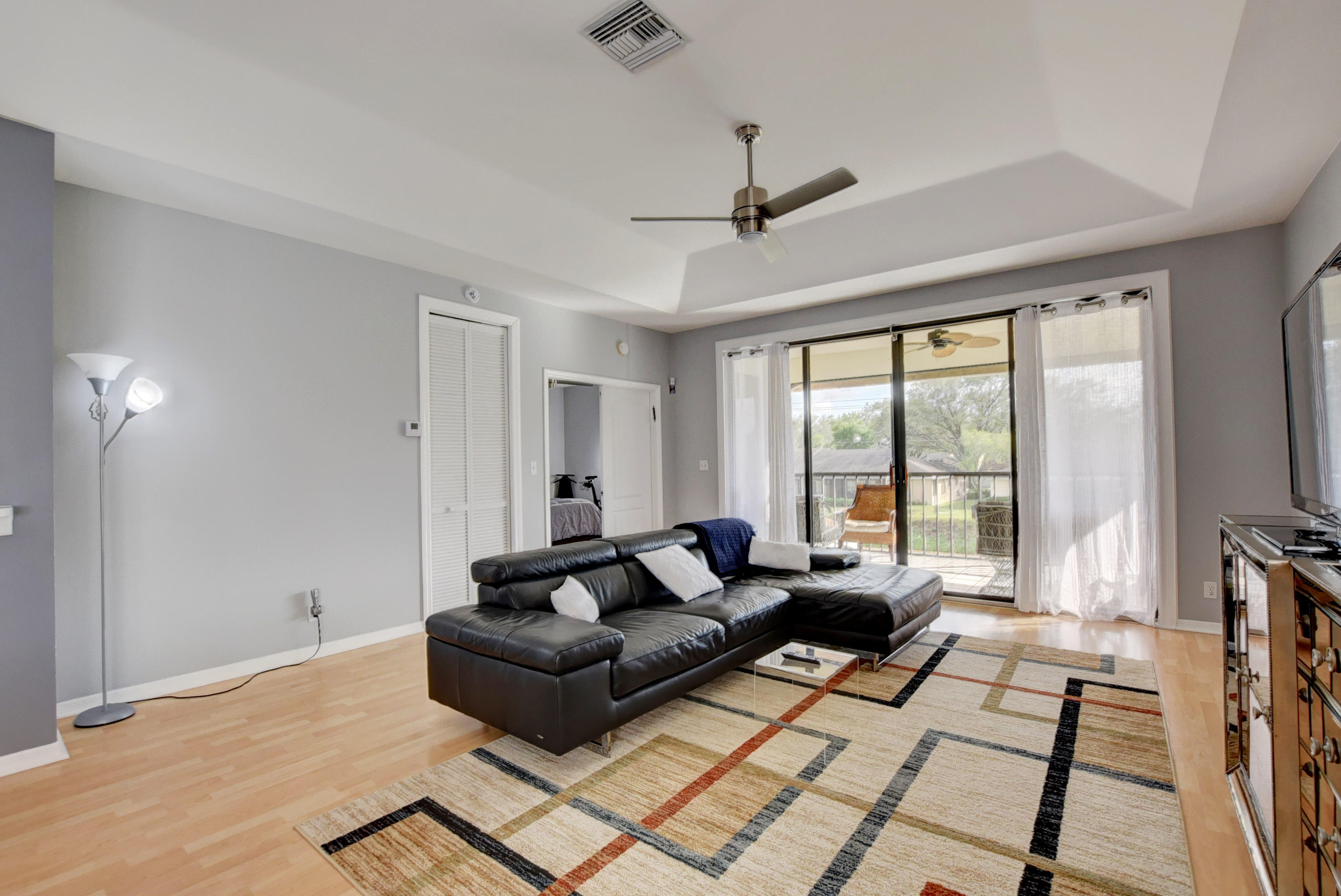 8682 Vía Reale, Unit 4 Boca Raton, FL 33496 - Photo 11 of 51 a living room with furniture and a flat screen tv