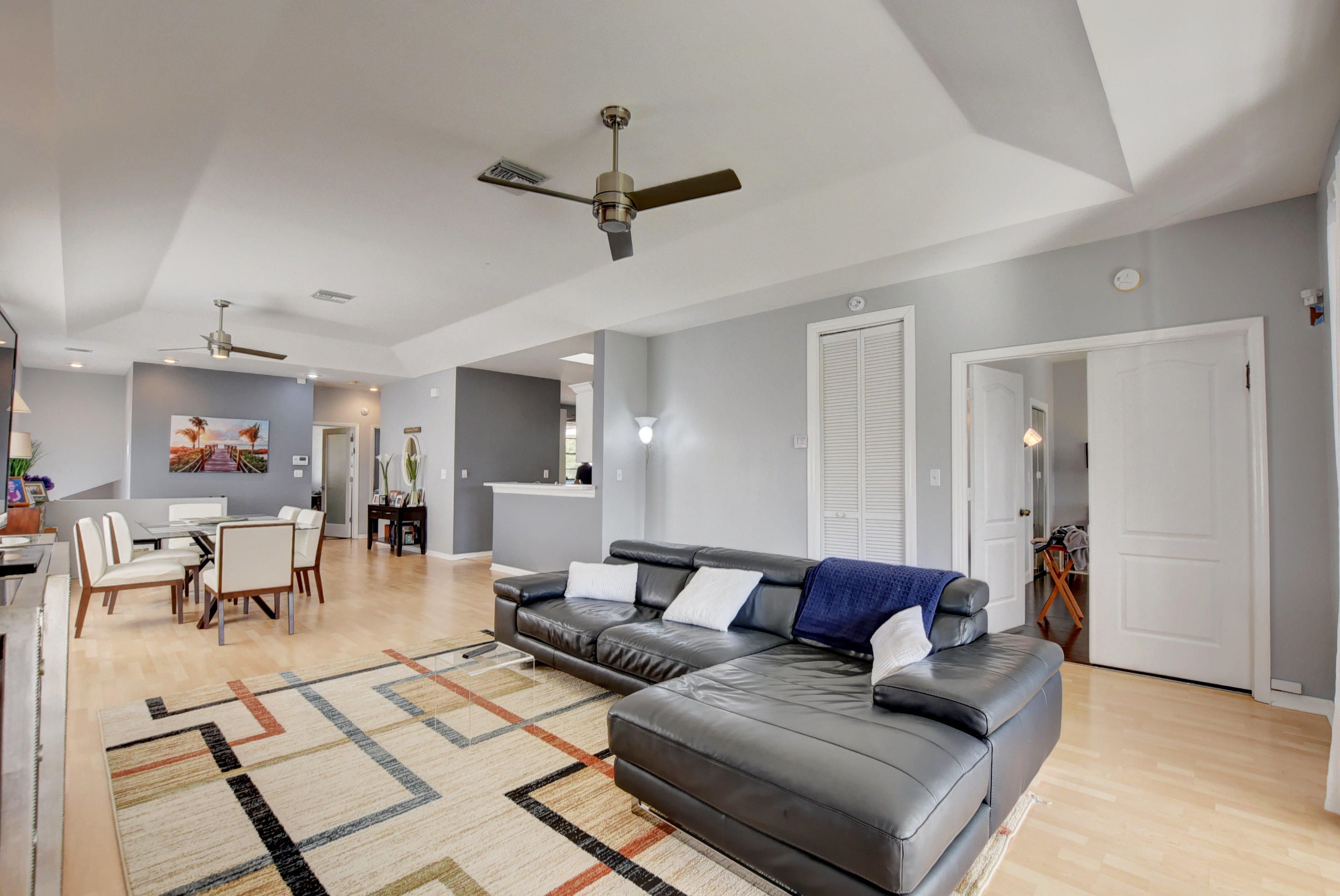 8682 Vía Reale, Unit 4 Boca Raton, FL 33496 - Photo 12 of 51 a living room with furniture and a dining table with kitchen view