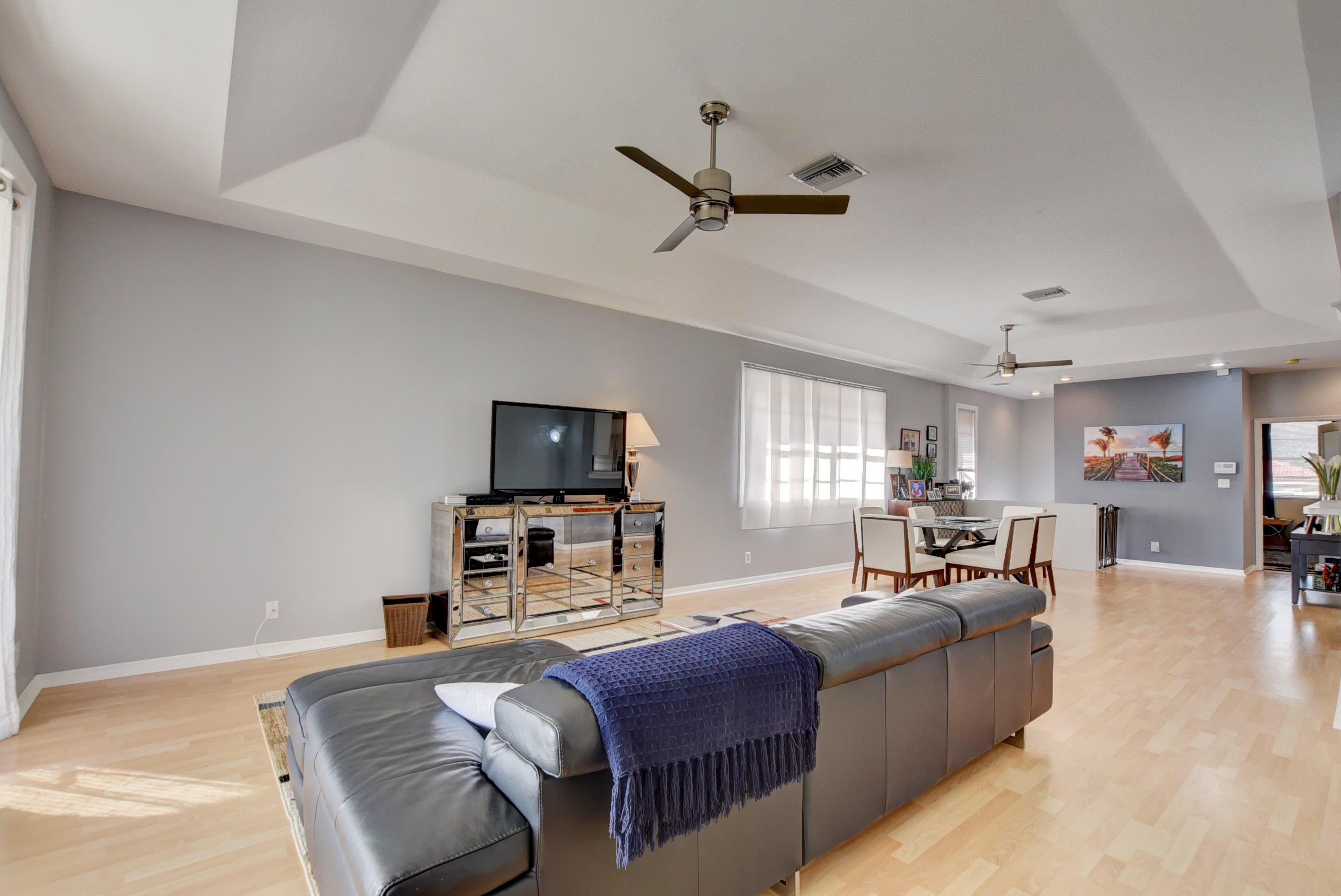 8682 Vía Reale, Unit 4 Boca Raton, FL 33496 - Photo 13 of 51 a bed room with a bed a couch and a window