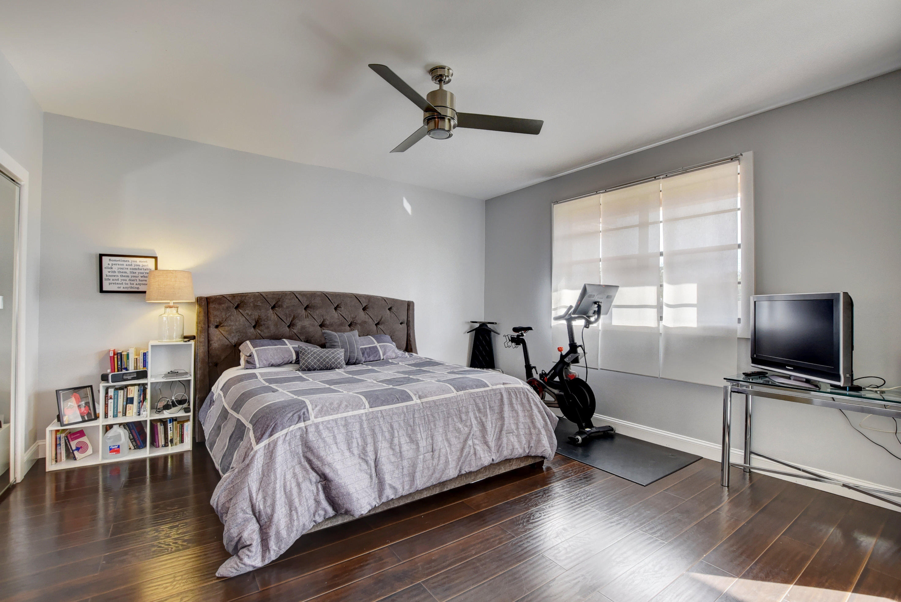 8682 Vía Reale, Unit 4 Boca Raton, FL 33496 - Photo 14 of 51 a bedroom with a bed and a flat screen tv