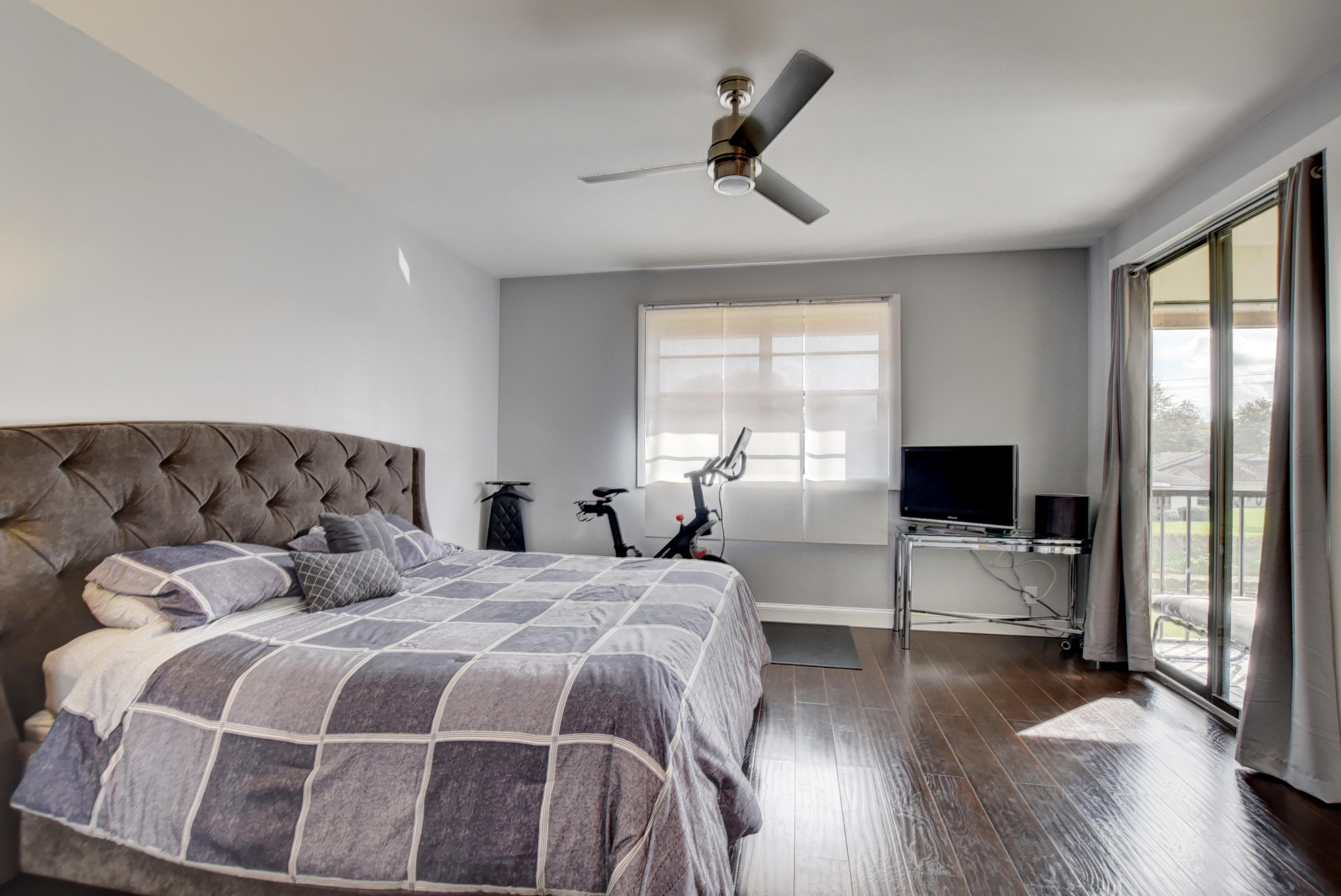 8682 Vía Reale, Unit 4 Boca Raton, FL 33496 - Photo 15 of 51 a bedroom with double bed and a large window