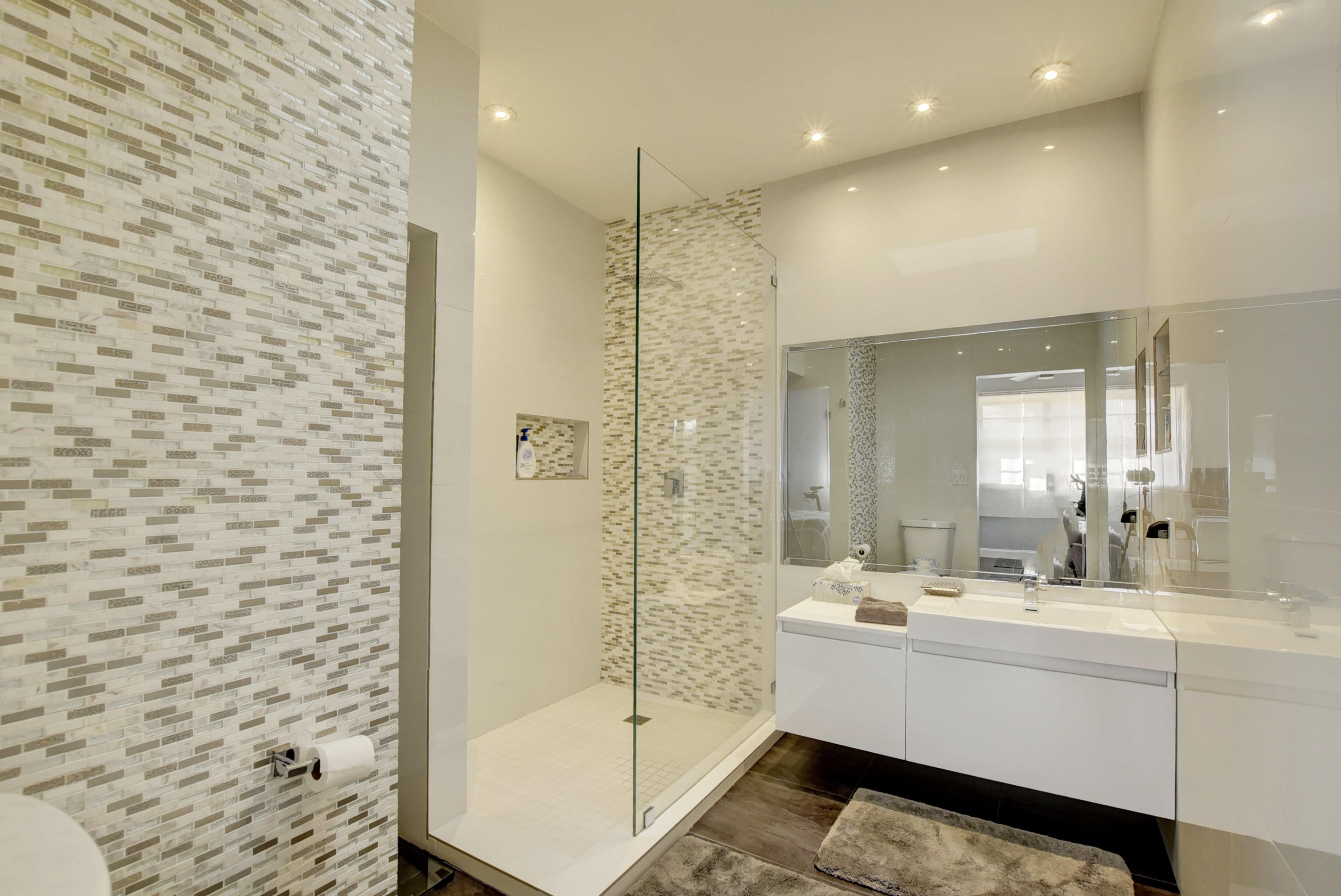 8682 Vía Reale, Unit 4 Boca Raton, FL 33496 - Photo 17 of 51 a bathroom with a shower sink and mirror