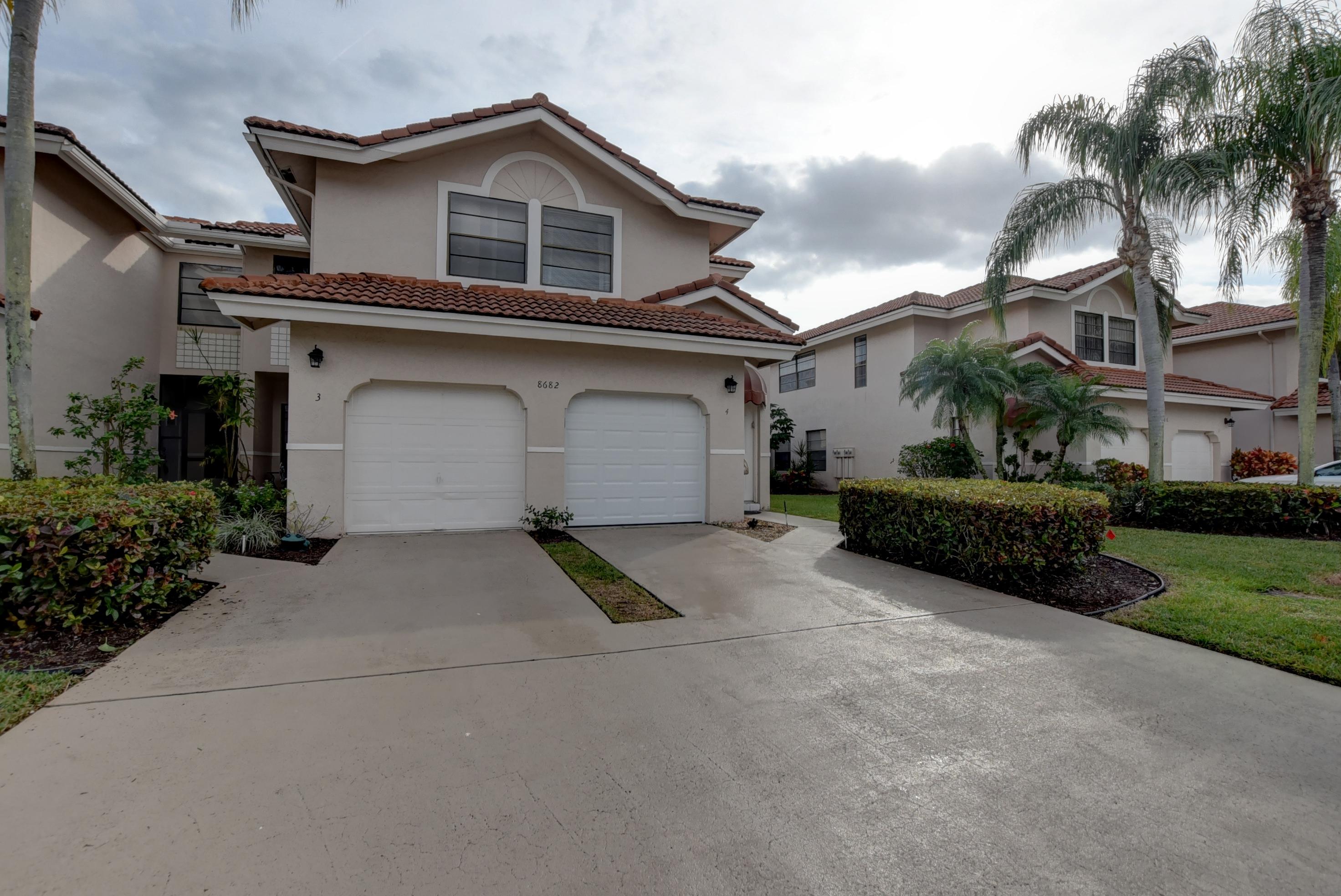 8682 Vía Reale, Unit 4 Boca Raton, FL 33496 - Photo 2 of 51 a house view with a garden space