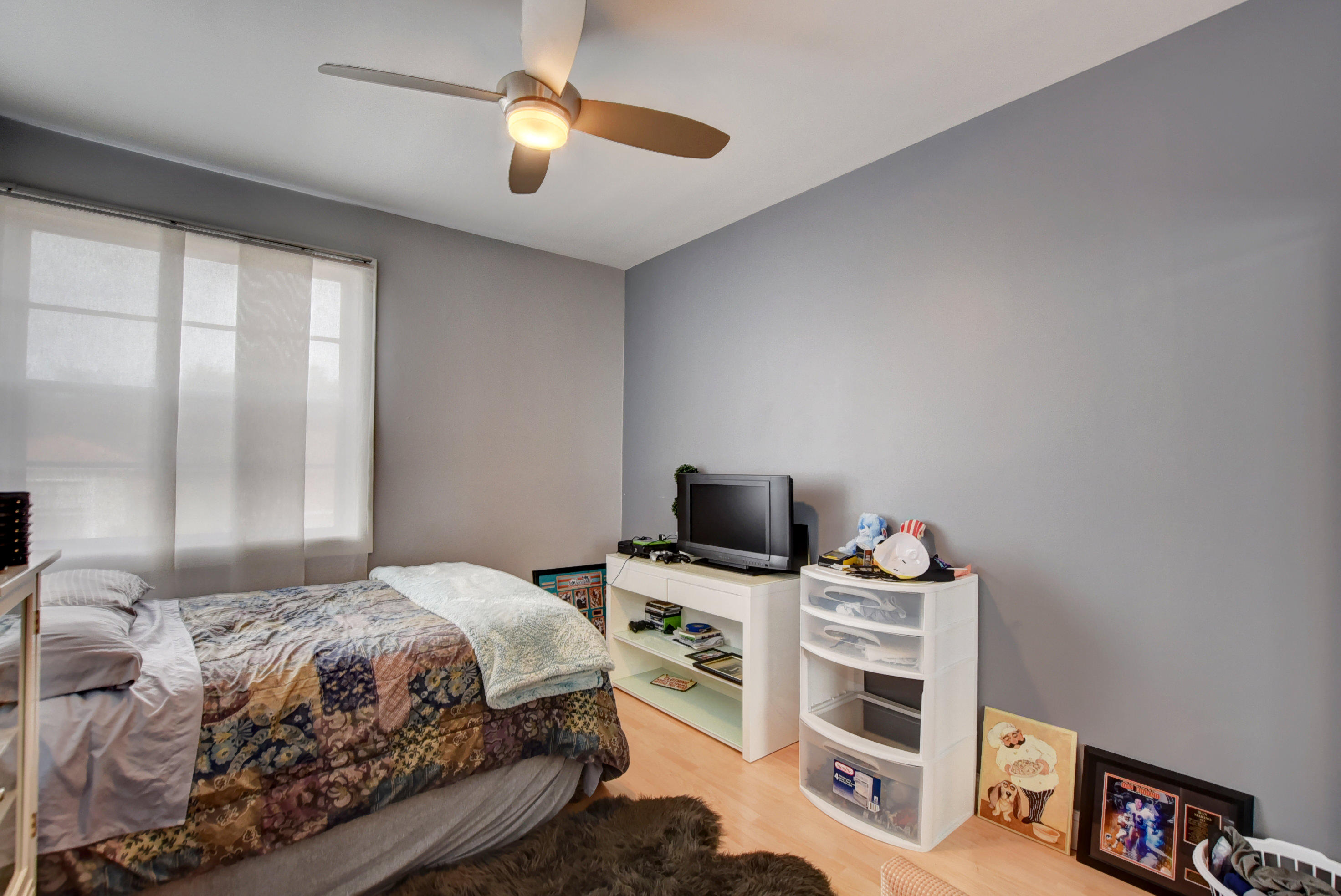 8682 Vía Reale, Unit 4 Boca Raton, FL 33496 - Photo 23 of 51 a bedroom with a bed and a flat screen tv