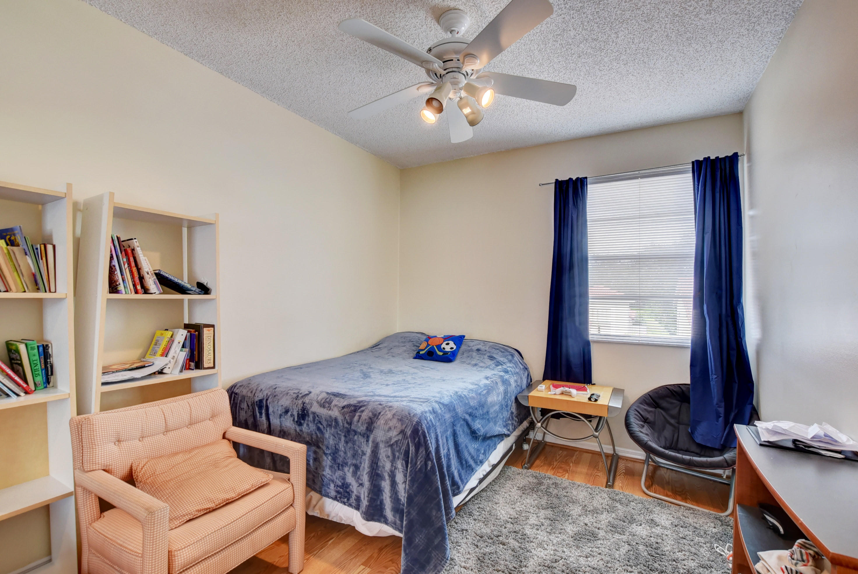 8682 Vía Reale, Unit 4 Boca Raton, FL 33496 - Photo 24 of 51 a bedroom with a bed and a book shelf