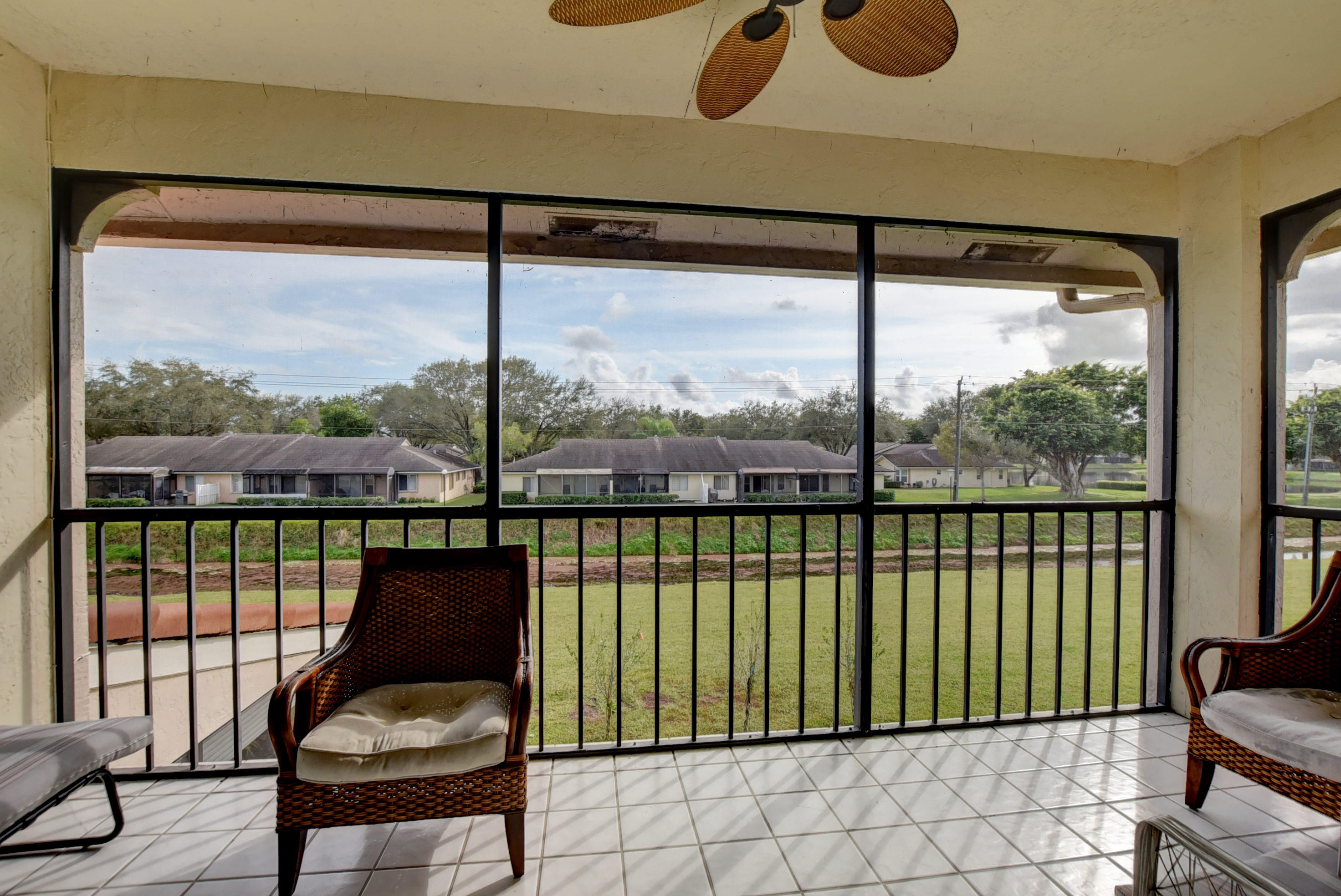 8682 Vía Reale, Unit 4 Boca Raton, FL 33496 - Photo 26 of 51 a living room filled with furniture and floor to ceiling window