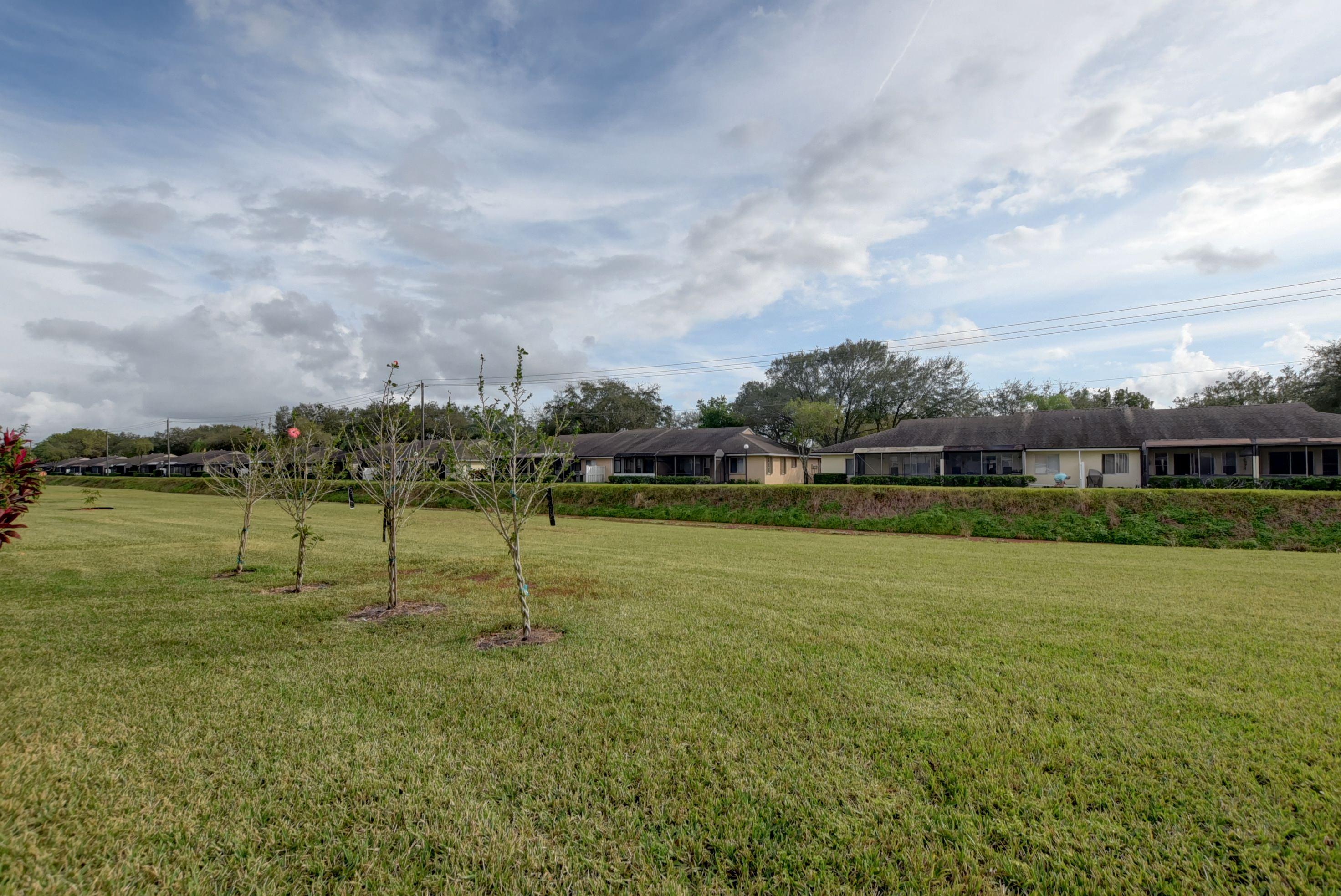 8682 Vía Reale, Unit 4 Boca Raton, FL 33496 - Photo 32 of 51 a view of a golf course with a lake