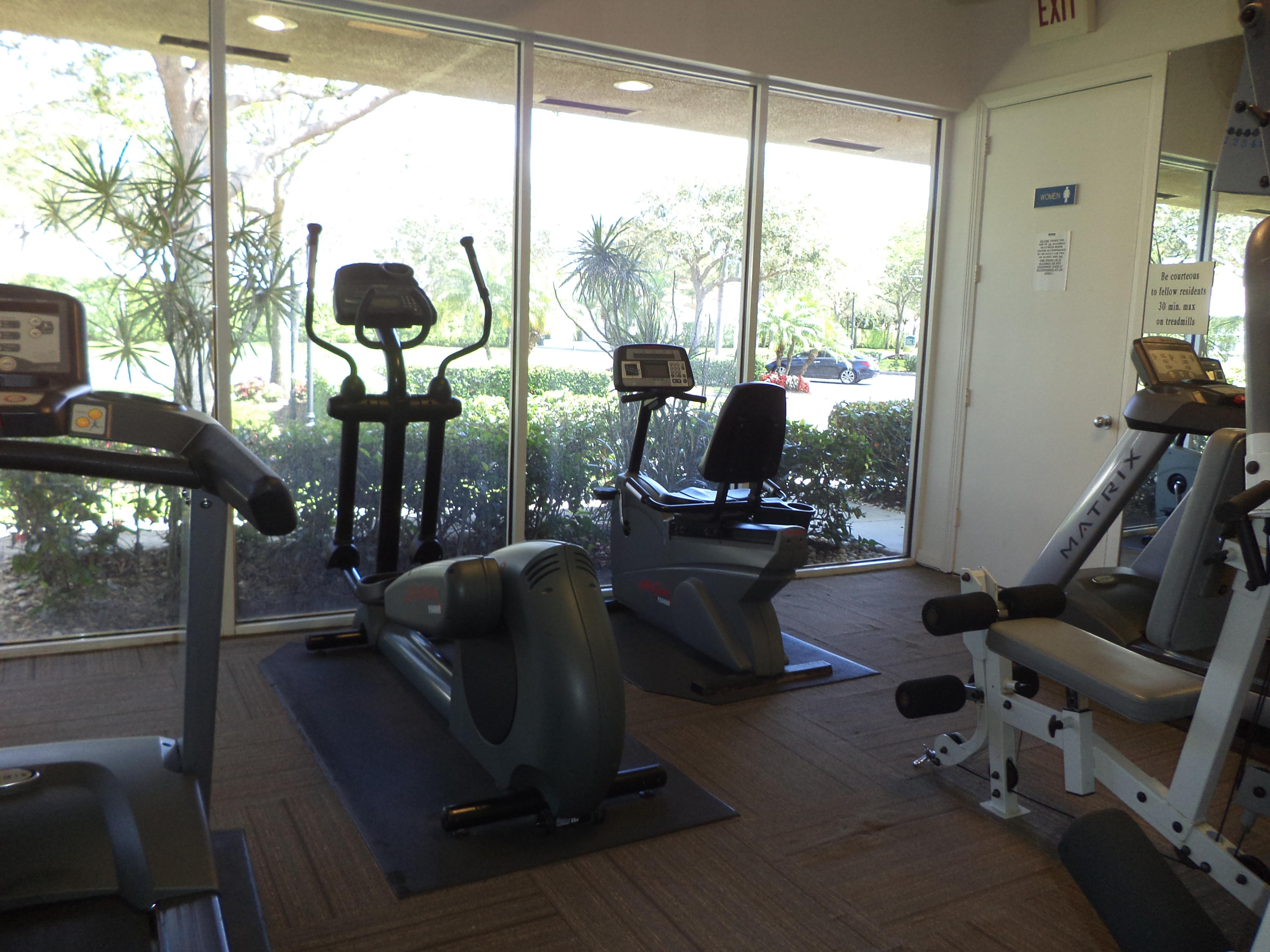 8682 Vía Reale, Unit 4 Boca Raton, FL 33496 - Photo 43 of 51 a room with gym equipment and a large window