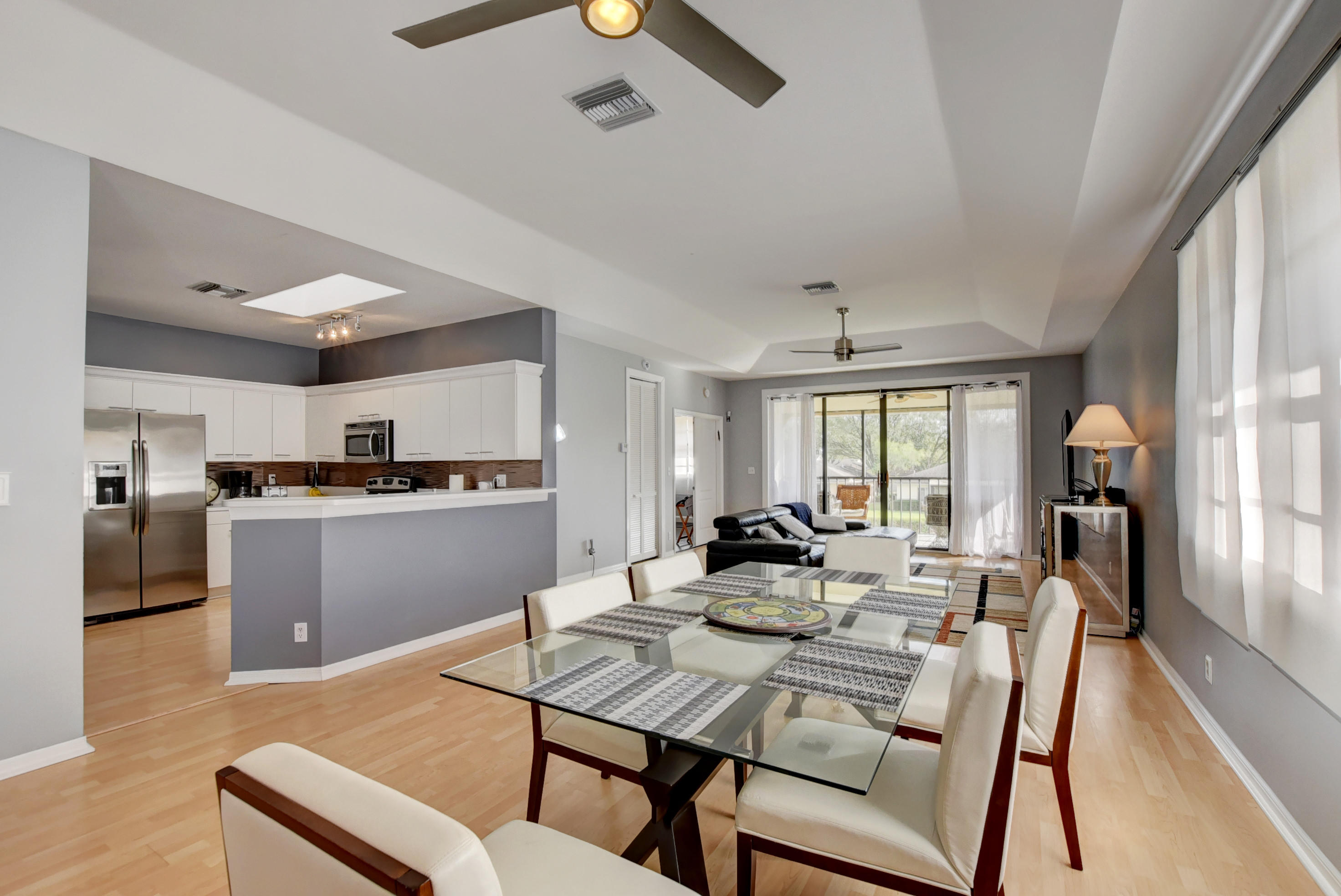 8682 Vía Reale, Unit 4 Boca Raton, FL 33496 - Photo 9 of 51 a view of a dining room with furniture window and wooden floor