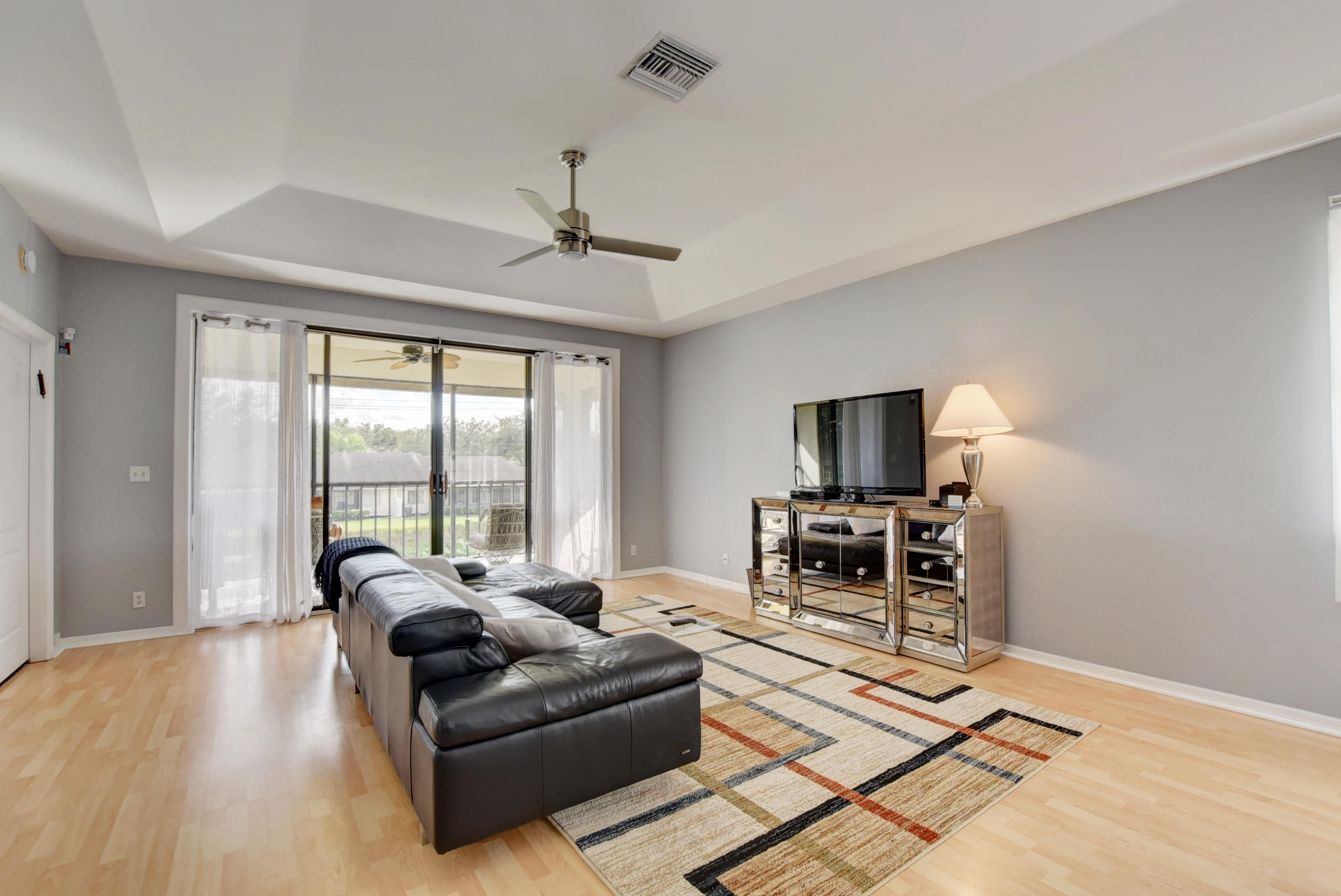 8682 Vía Reale, Unit 4 Boca Raton, FL 33496 - Photo 10 of 51 a living room with furniture and a flat screen tv