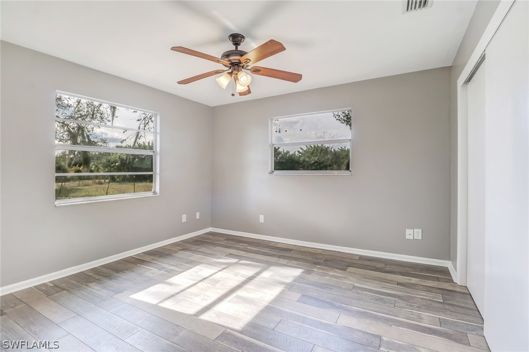 5381 Jackson Road Fort Myers, FL 33905 - Photo 12 of 23 a view of empty room with wooden floor and fan