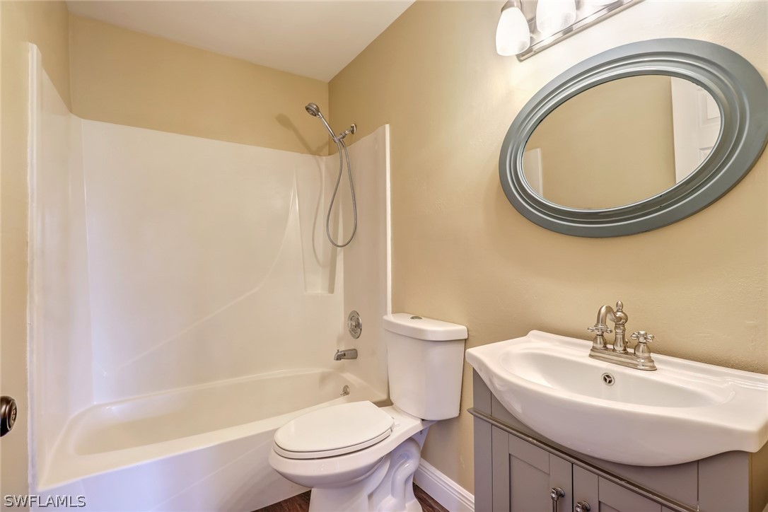 5381 Jackson Road Fort Myers, FL 33905 - Photo 13 of 23 a bathroom with a sink a toilet and a mirror