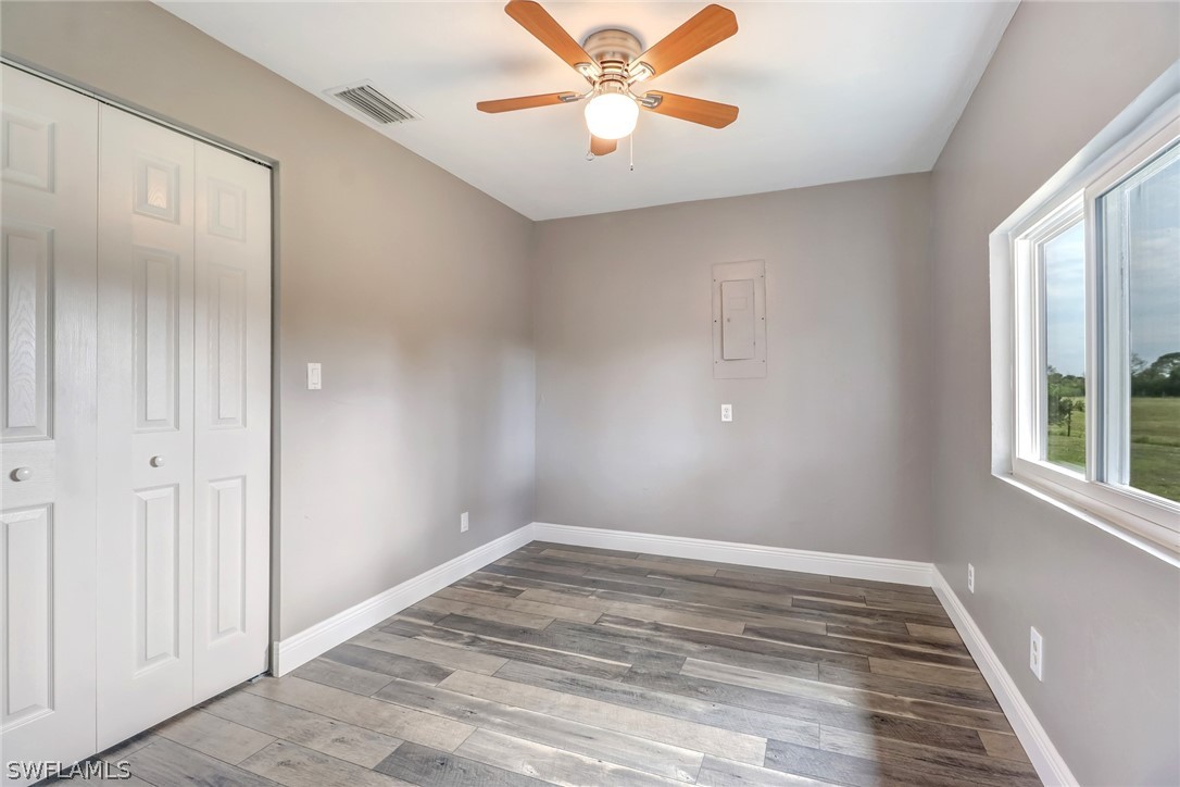 5381 Jackson Road Fort Myers, FL 33905 - Photo 14 of 23 wooden floor in an empty room with a window