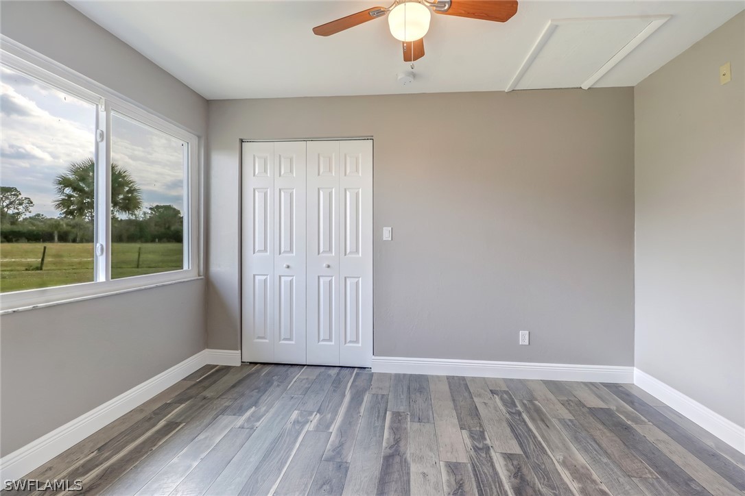 5381 Jackson Road Fort Myers, FL 33905 - Photo 15 of 23 an empty room with wooden floor and windows