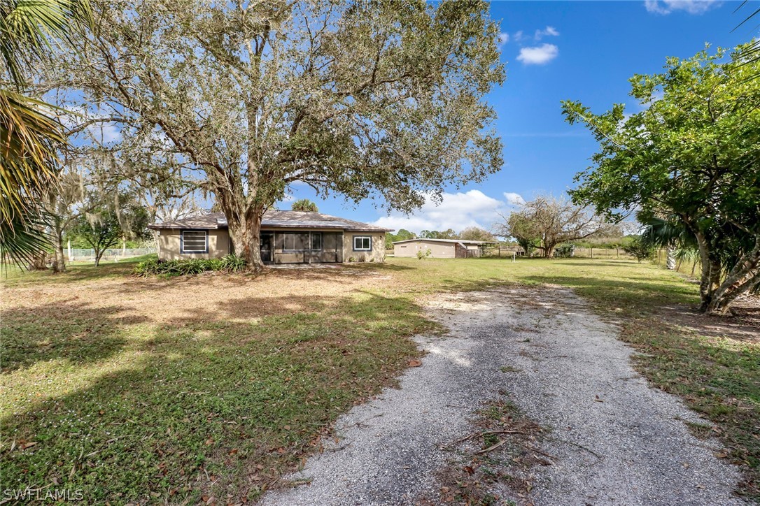5381 Jackson Road Fort Myers, FL 33905 - Photo 2 of 23 a view of a yard with plants and trees