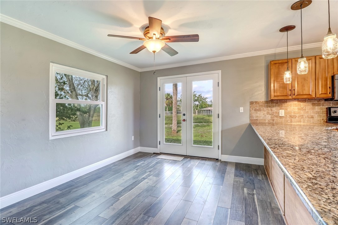5381 Jackson Road Fort Myers, FL 33905 - Photo 7 of 23 a view of a room with wooden floor and a ceiling fan