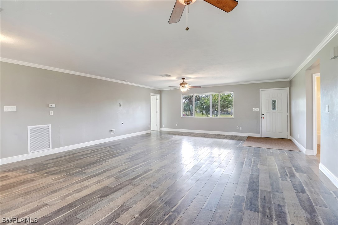 5381 Jackson Road Fort Myers, FL 33905 - Photo 8 of 23 wooden floor in an empty room with a window