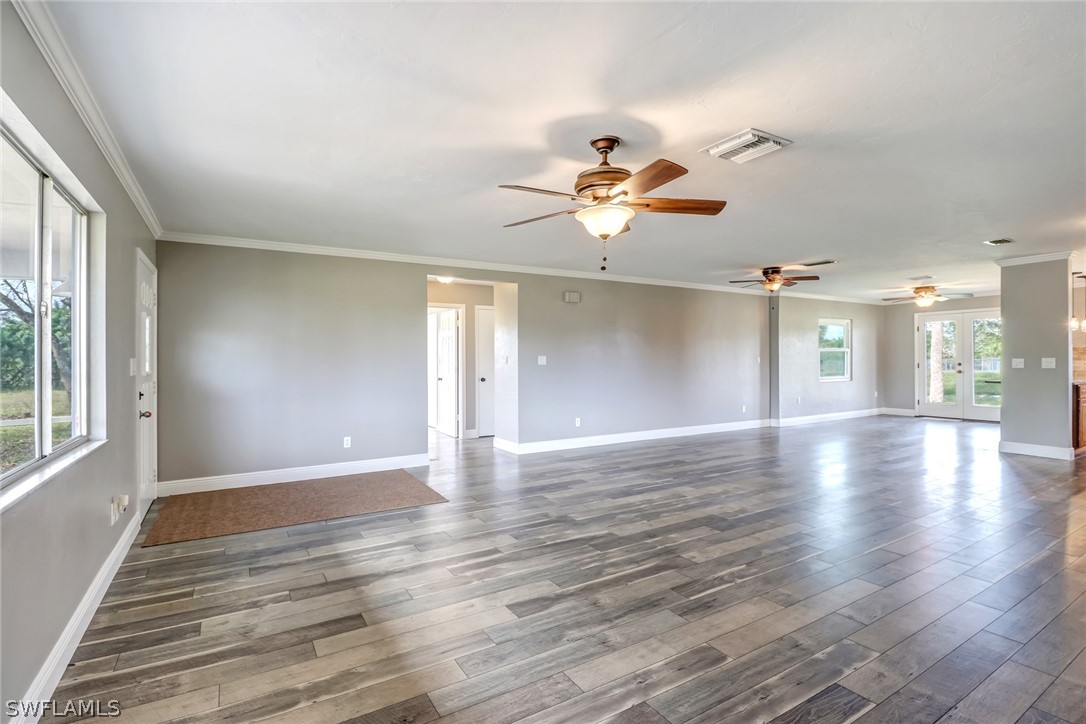 5381 Jackson Road Fort Myers, FL 33905 - Photo 9 of 23 wooden floor in an empty room with a window