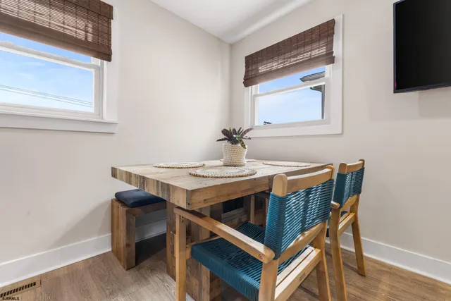 a kitchen with stainless steel appliances a refrigerator and wooden floor