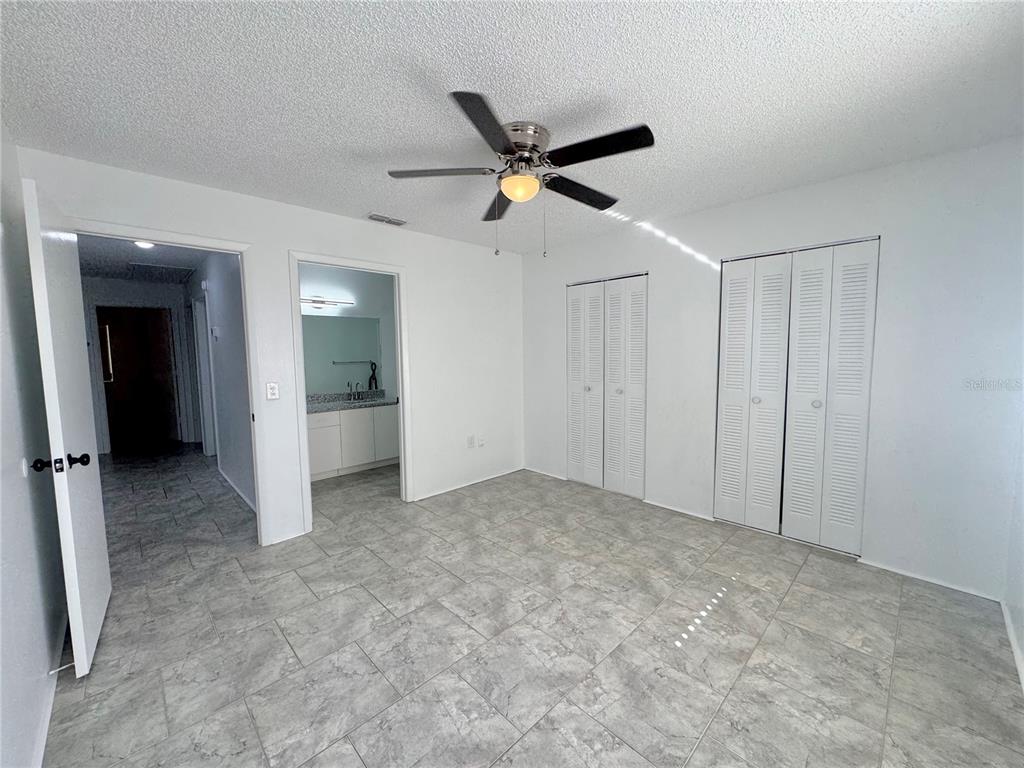 292 Winter Ridge Boulevard, Unit 292 Winter Haven, FL 33881 - Photo 11 of 37 an empty room with closet and a ceiling fan
