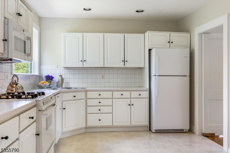 416 Rosemont Ringoes Road Stockton, NJ 08559 - Photo 19 of 39 a kitchen with white cabinets and refrigerator