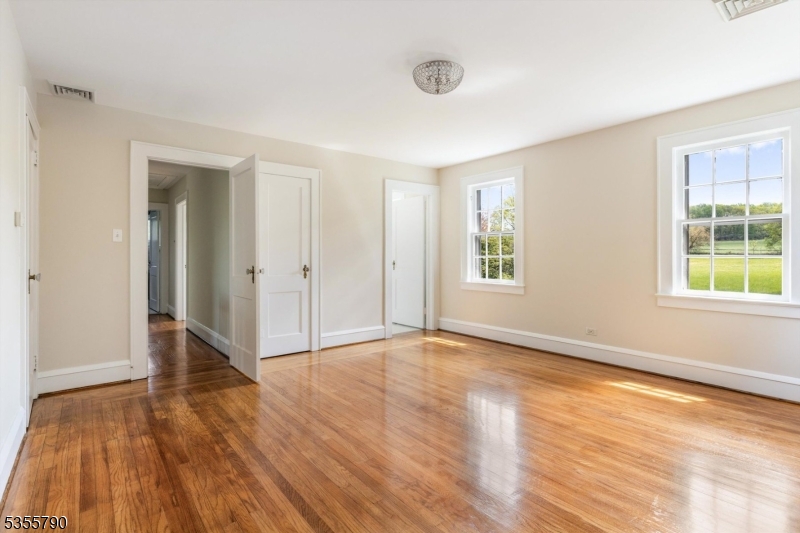 416 Rosemont Ringoes Road Stockton, NJ 08559 - Photo 23 of 39 an empty room with wooden floor and windows