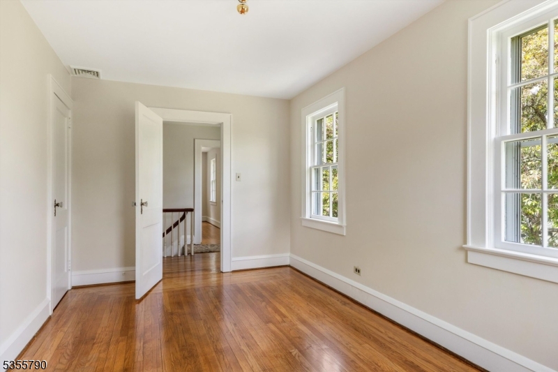 416 Rosemont Ringoes Road Stockton, NJ 08559 - Photo 26 of 39 an empty room with wooden floor and windows