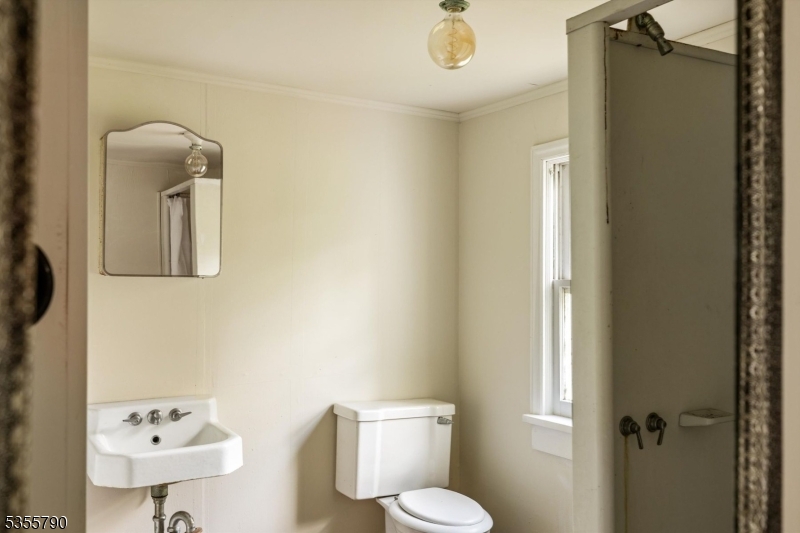 416 Rosemont Ringoes Road Stockton, NJ 08559 - Photo 35 of 39 a bathroom with a toilet sink vanity and mirror