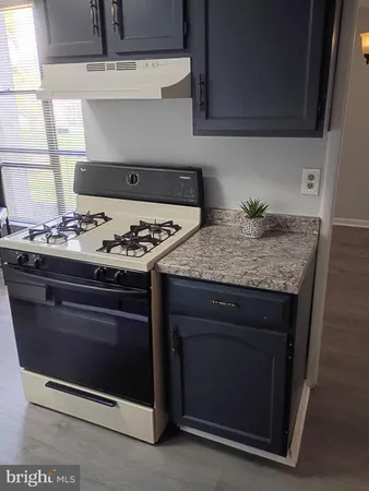 a stove top oven sitting inside of a kitchen